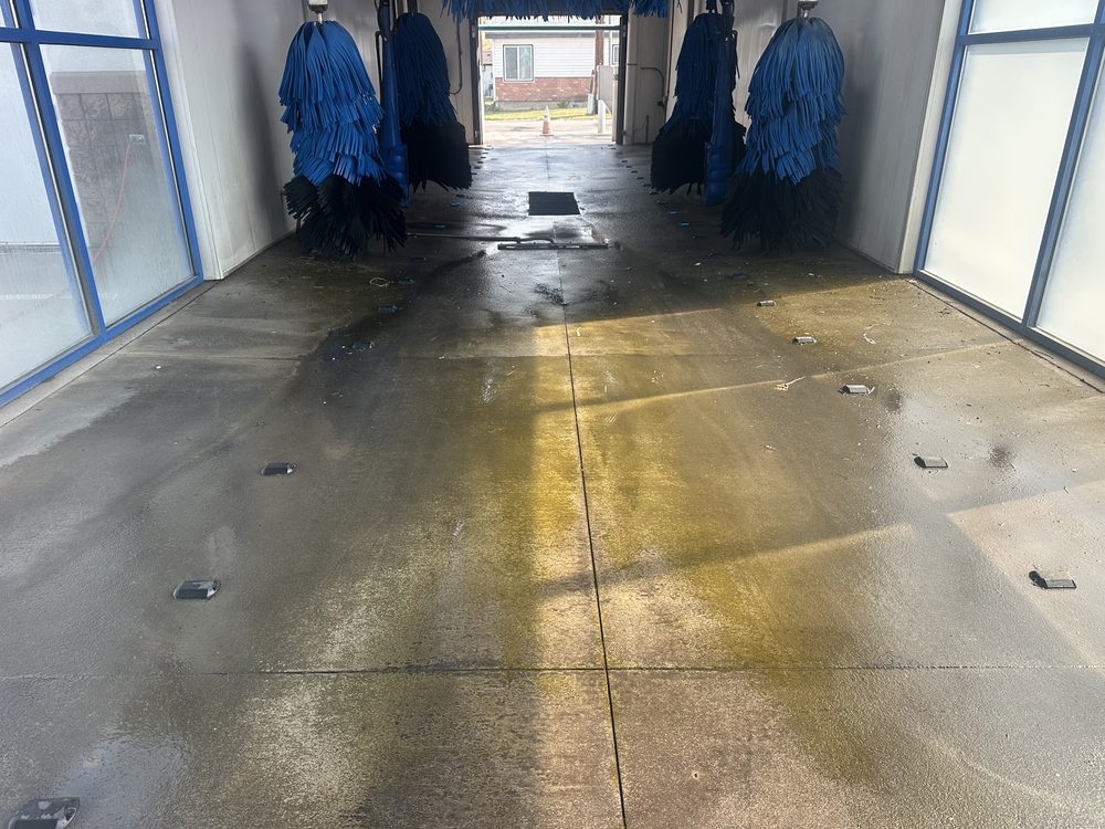 Car wash tunnel wash-down in progress